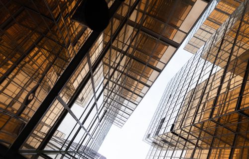 Golden building. Windows glass of modern office skyscrapers in technology and business concept. Facade design. Construction structure of architecture exterior for urban cityscape background.